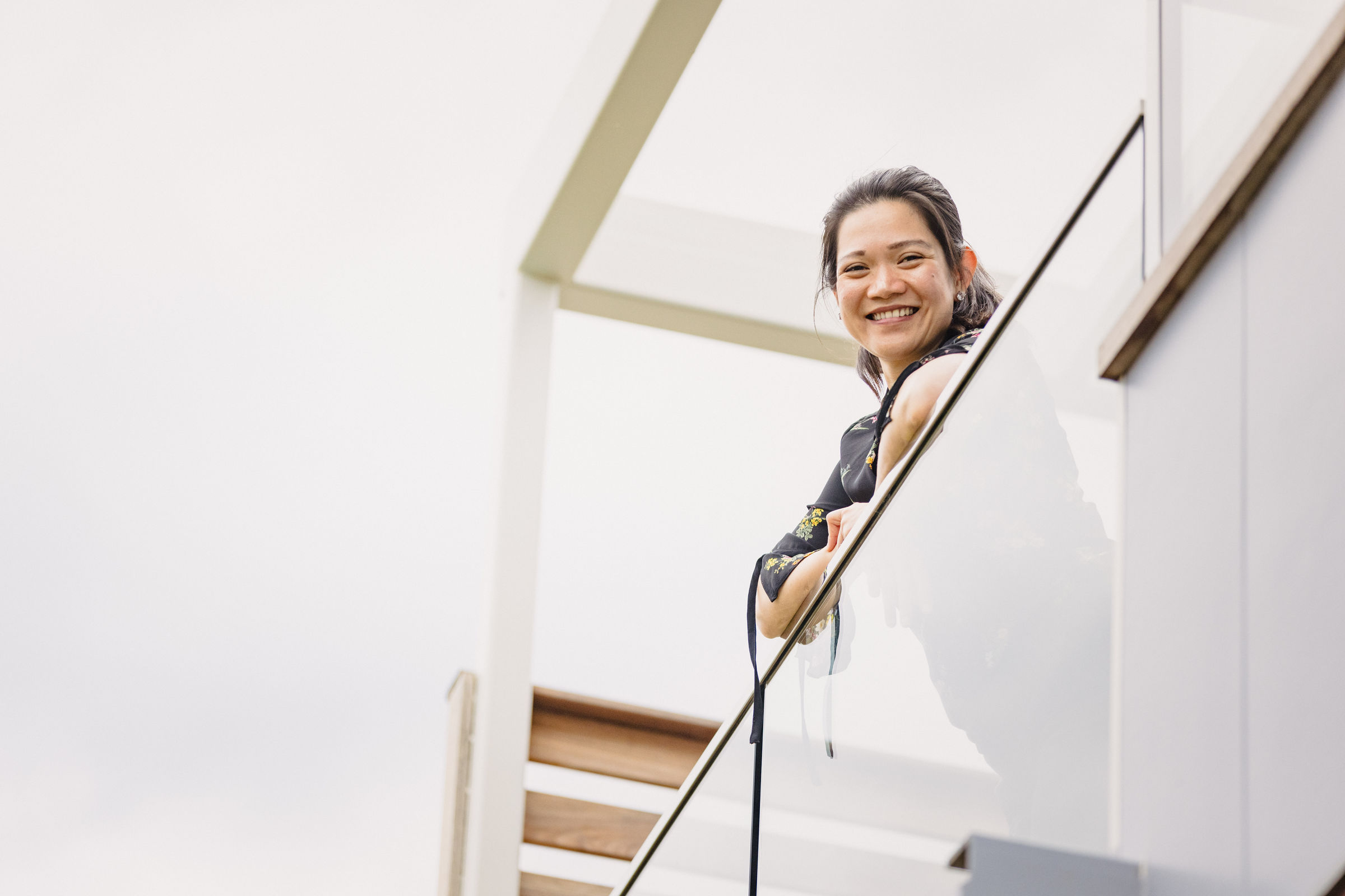 A very happy client standing on her new deck with a glass balustrade to take full advantage of the view. Credit: Jordan Davis.