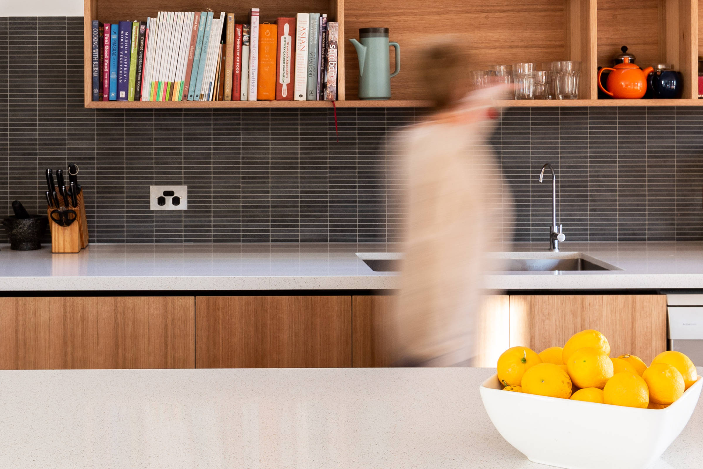 Open plan kitchen renovation which flows seamlessly to the living area, Tasmanian oak joinery, stone benchtop, custom renovation and improving natural light into the kitchen and living areas. Credit: Jordan Davis.