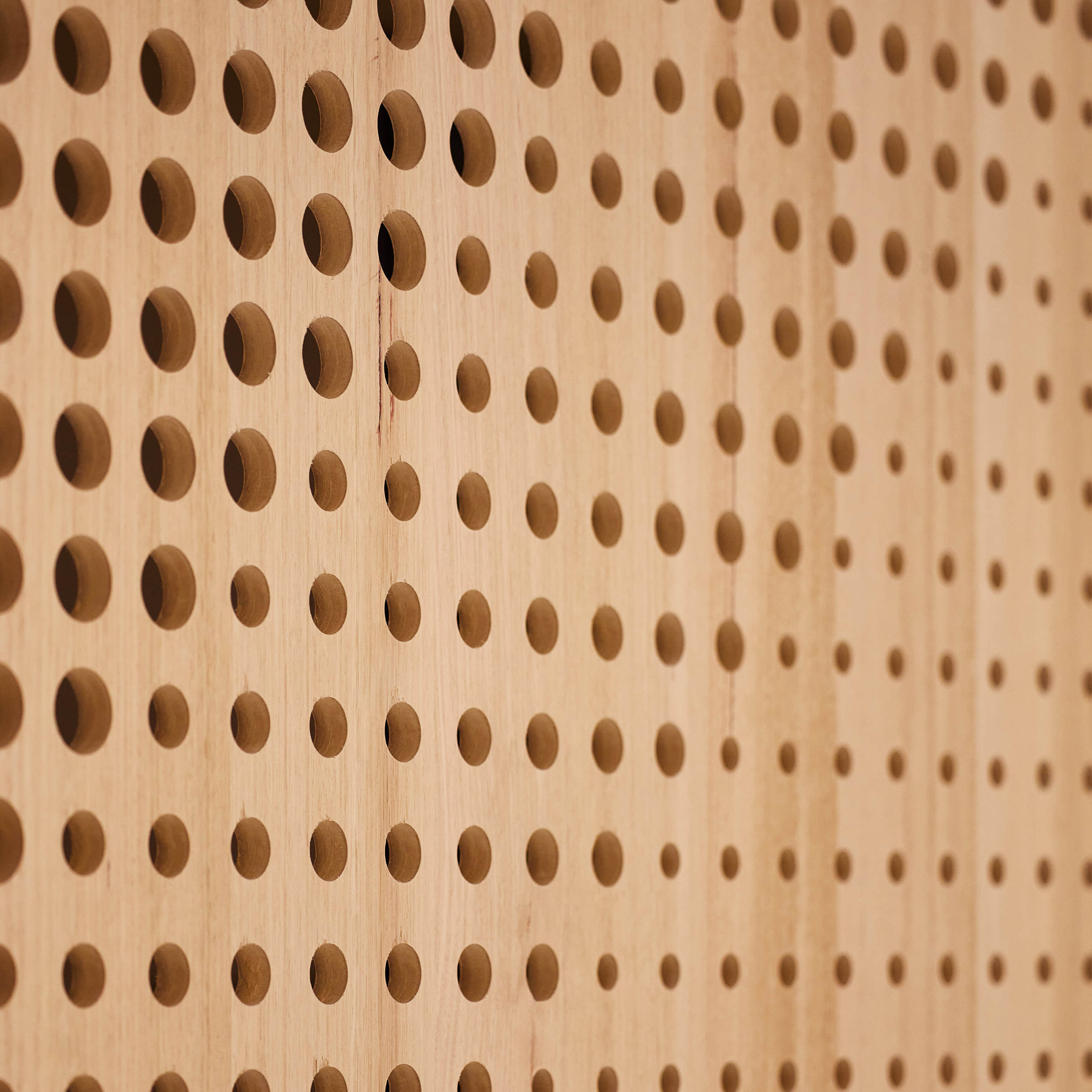 Internal detailing of Tasmanian oak style plywood that has been laser cut with a large number of ventilation holes of varying sizes to look both attractive and fulfil a function. Credit: Samuel Shelley.