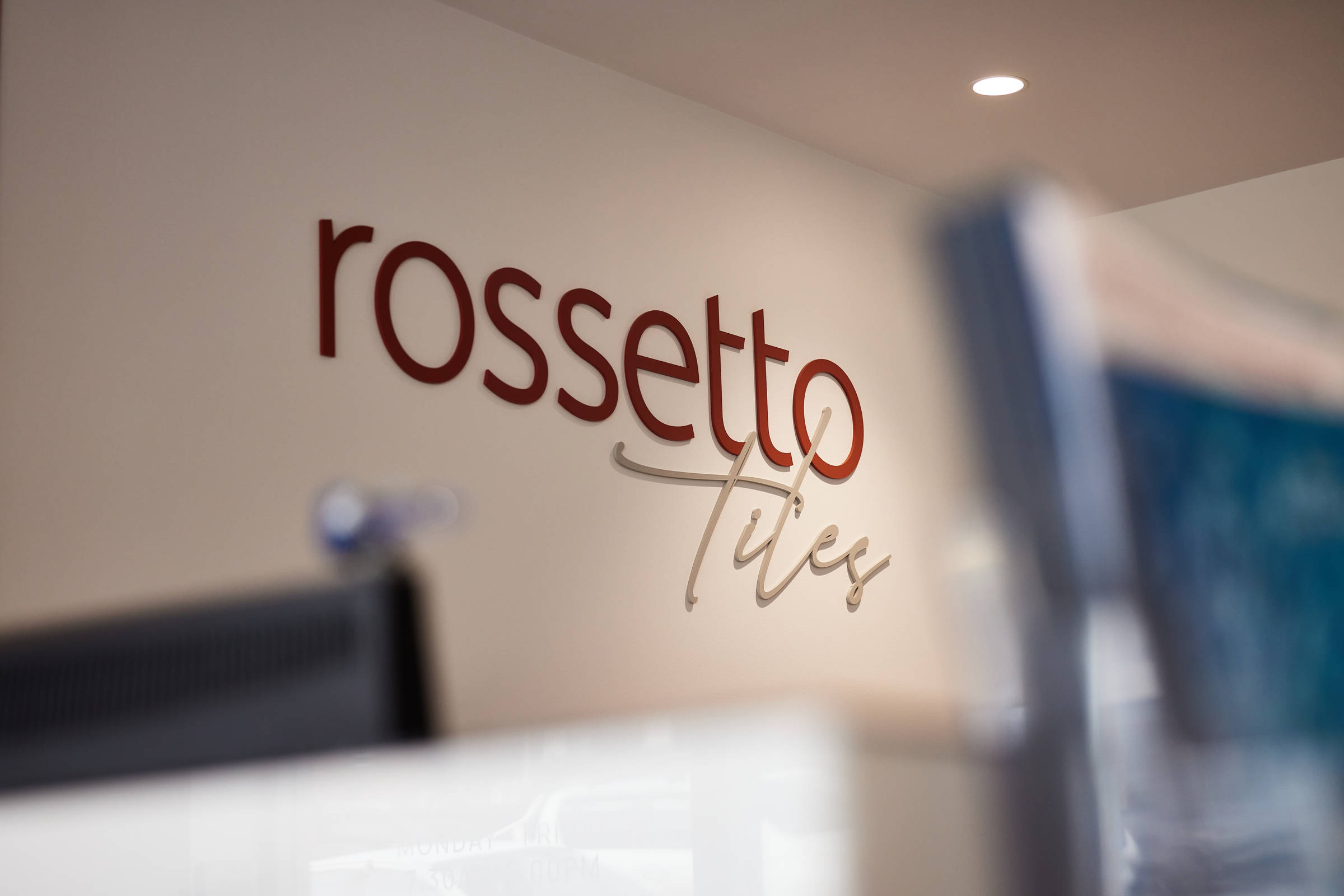 Closeup and well-lit image of the Rossetto Tiles logo on a wall. Credit: Samuel Shelley.