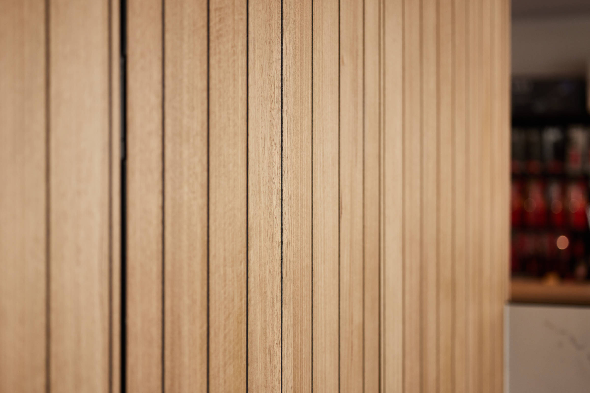 Closeup image of timber panelling that is neat and linear. Credit: Samuel Shelley.